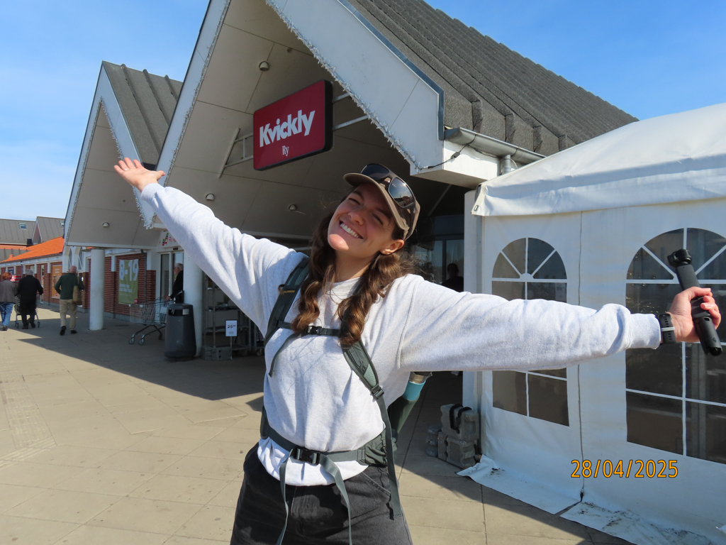 A girl standing outside a local supermarket in Ry, a small town near Skanderborg.